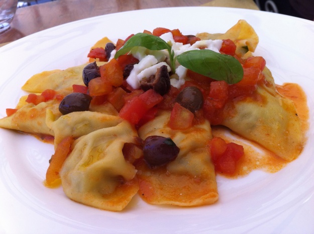 Ravioli with tomatoes and olives.